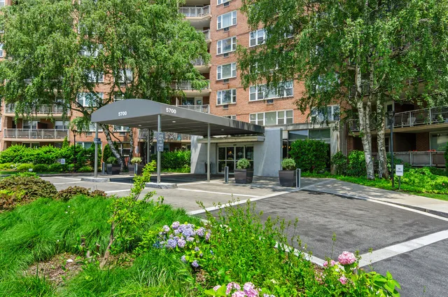 a front view of a house with yard and green space