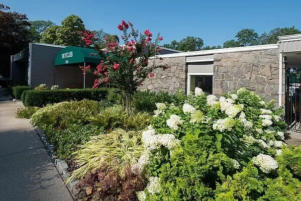 a view of a house with a flower garden