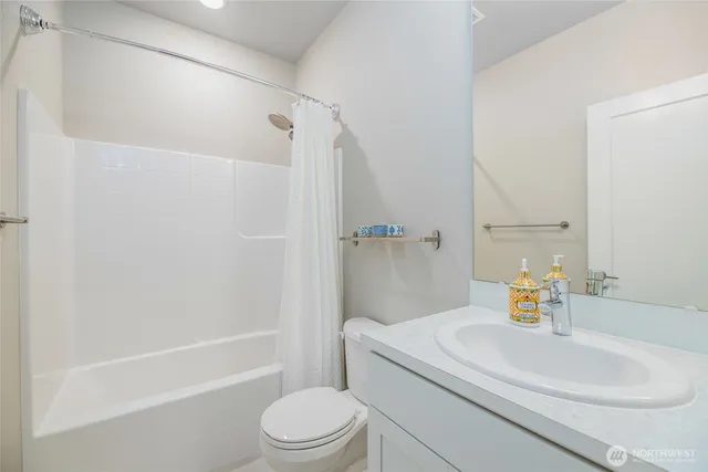 a bathroom with a sink a toilet and a shower