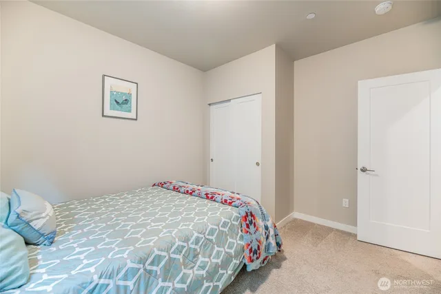 a bedroom with a bed and a wall painting