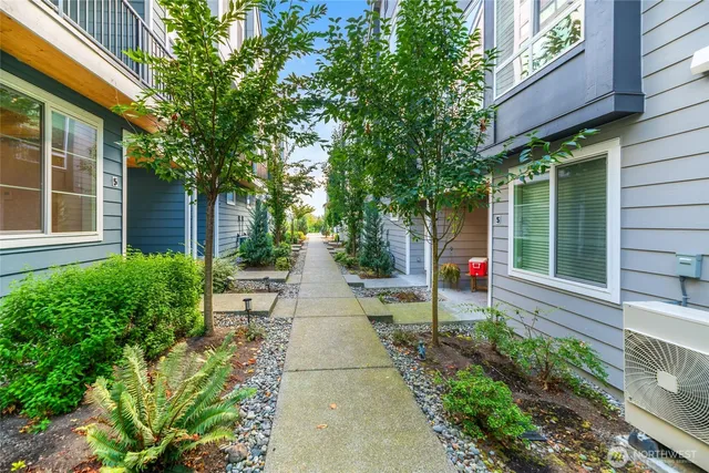 a front view of a house with a yard and outdoor seating