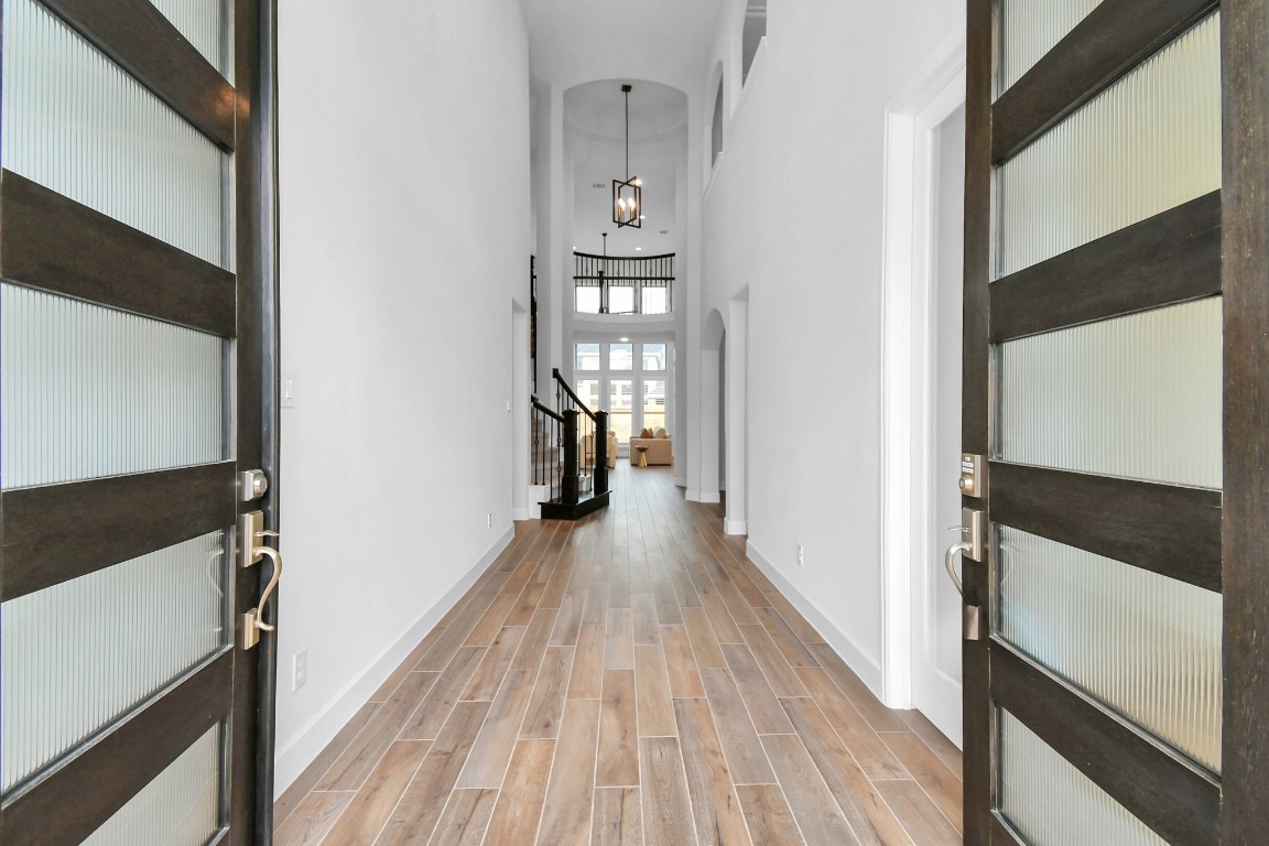 a view of hallway with wooden floor