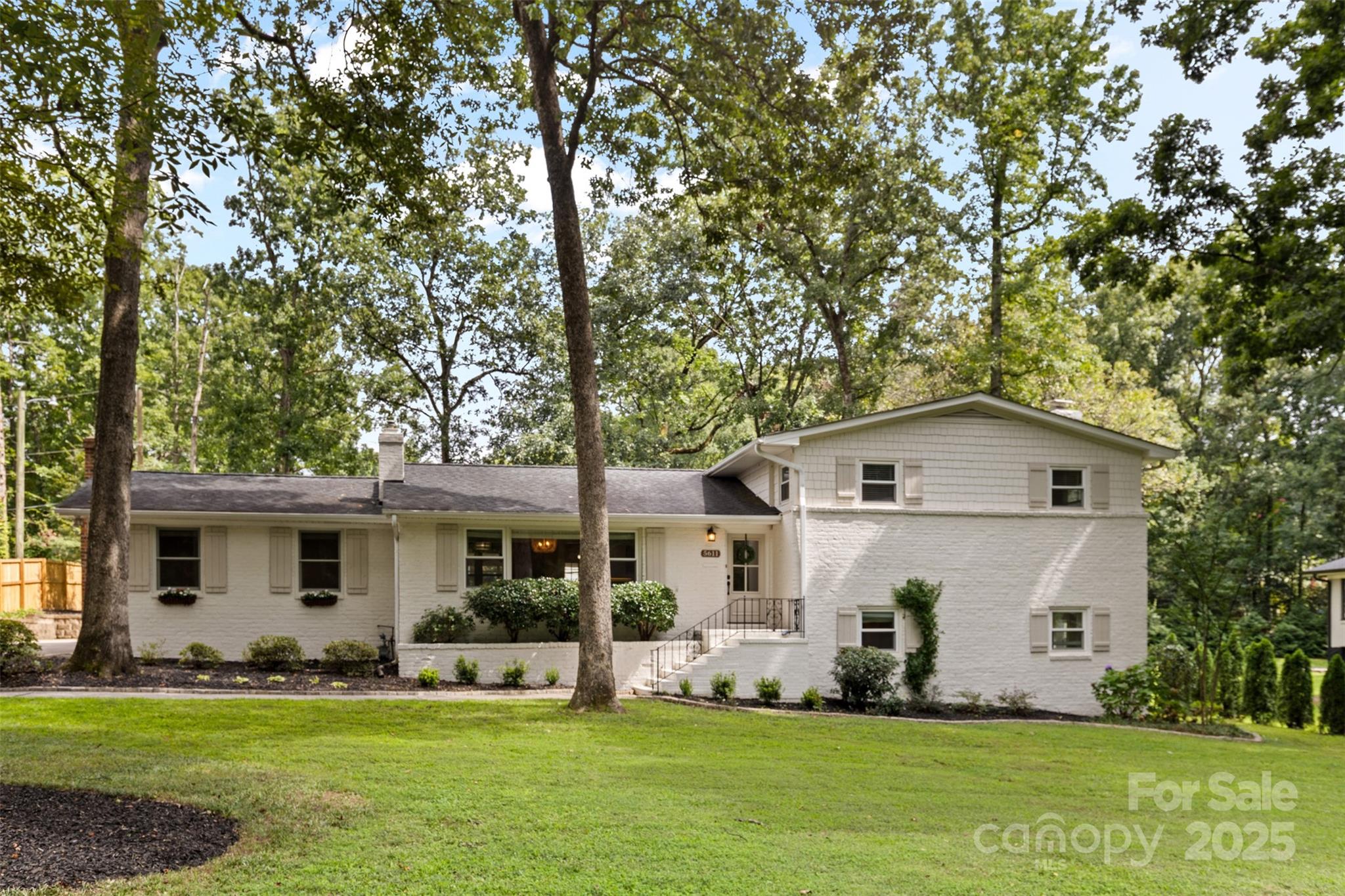 5611 Robinhood Road Charlotte, NC 28211 - Photo 2 of 48 a front view of a house with a garden and trees