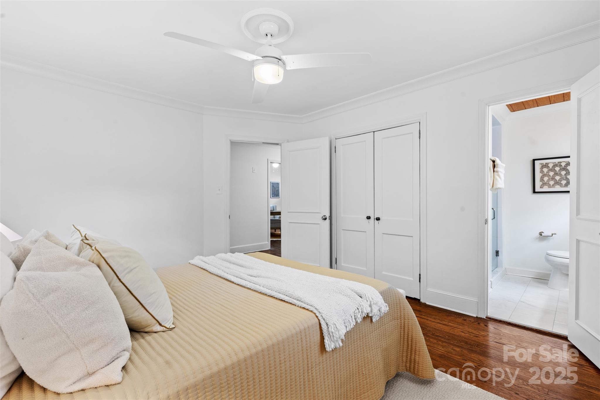 5611 Robinhood Road Charlotte, NC 28211 - Photo 22 of 48 a bedroom with a bed and a chandelier