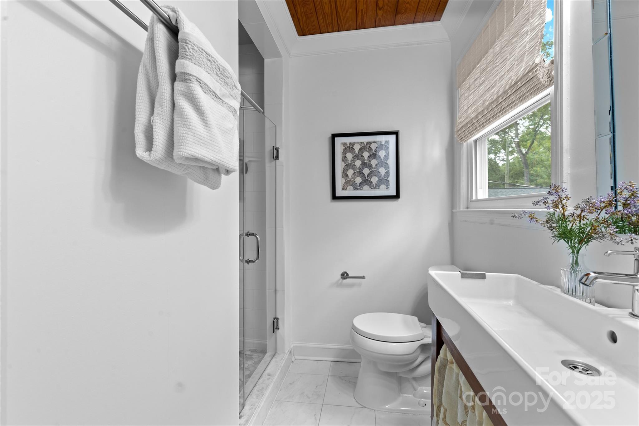 5611 Robinhood Road Charlotte, NC 28211 - Photo 23 of 48 a bathroom with a toilet sink and mirror