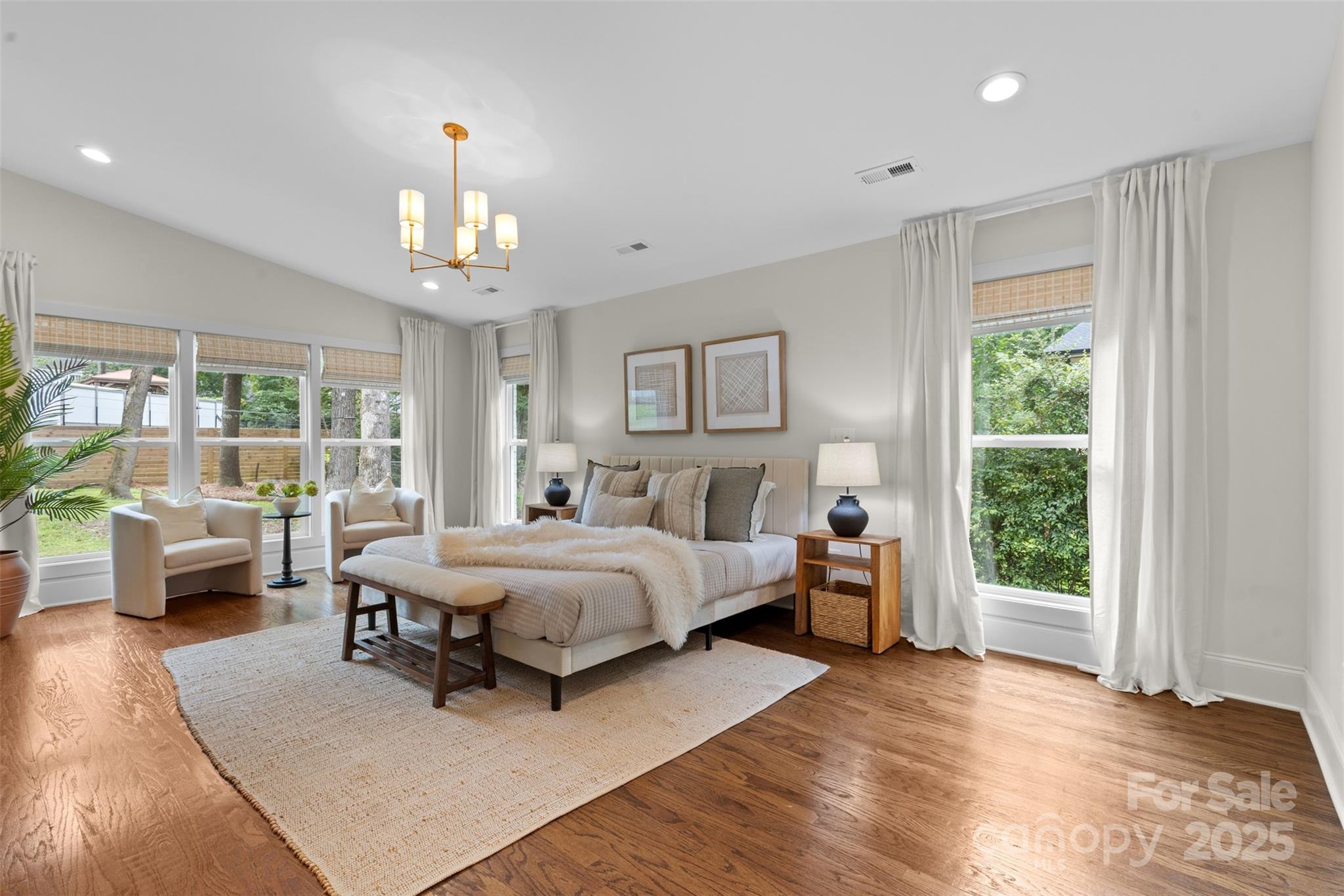 5611 Robinhood Road Charlotte, NC 28211 - Photo 25 of 48 a spacious bedroom with a large bed and a couch