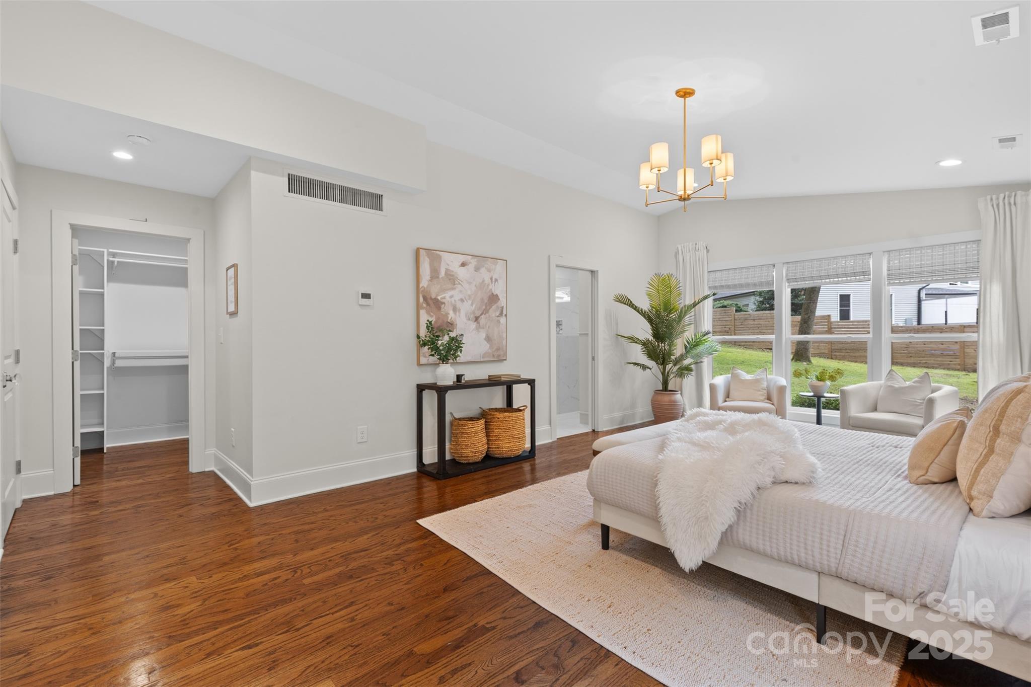 5611 Robinhood Road Charlotte, NC 28211 - Photo 26 of 48 a bedroom with a bed and a chandelier