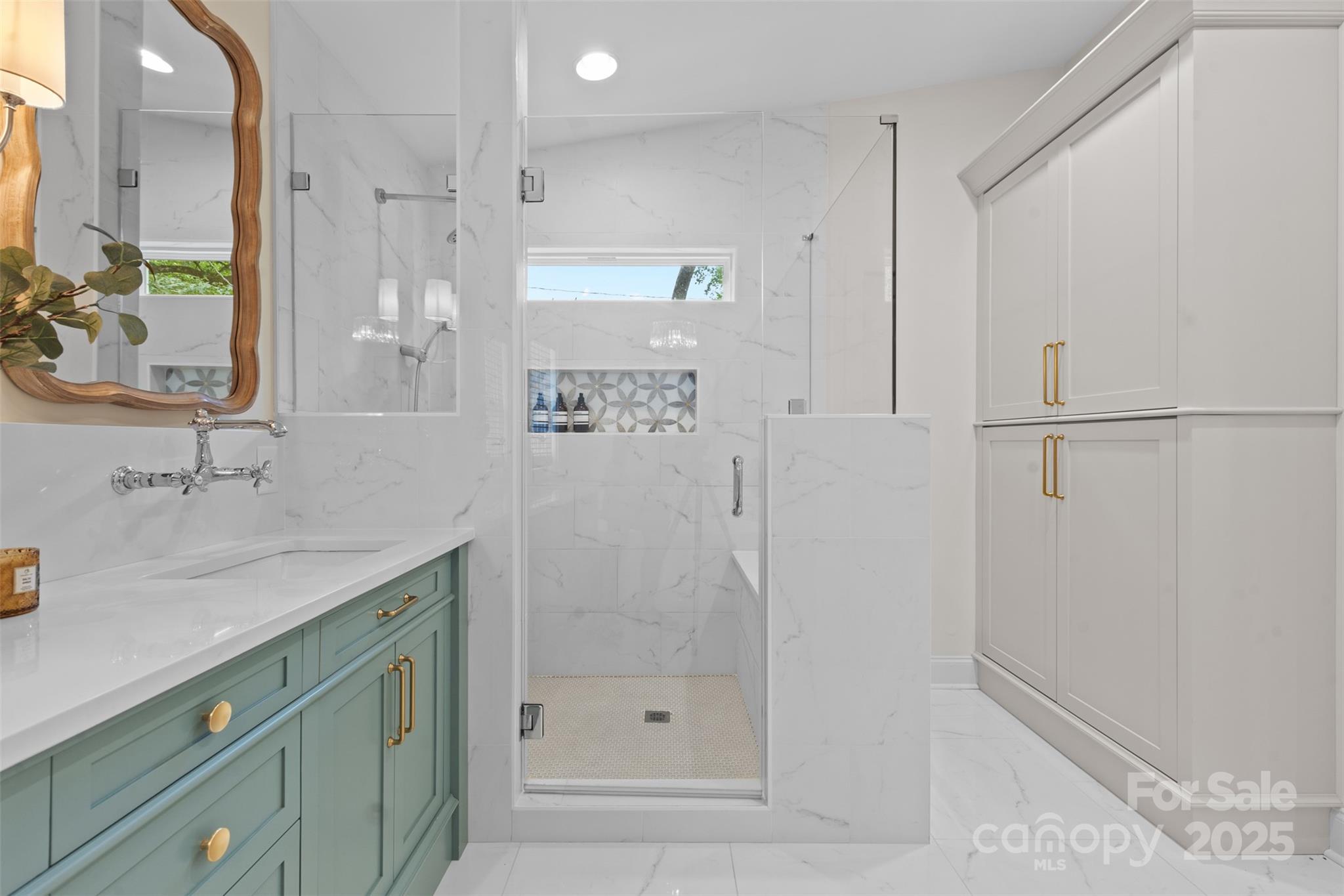 5611 Robinhood Road Charlotte, NC 28211 - Photo 32 of 48 a bathroom with a shower sink and mirror