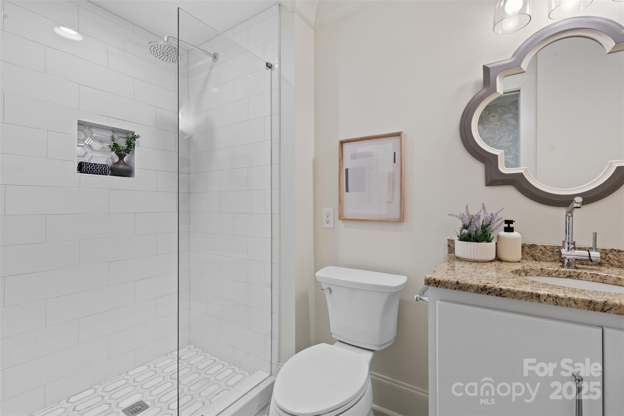 5611 Robinhood Road Charlotte, NC 28211 - Photo 36 of 48 a bathroom with a granite countertop sink mirror vanity and toilet