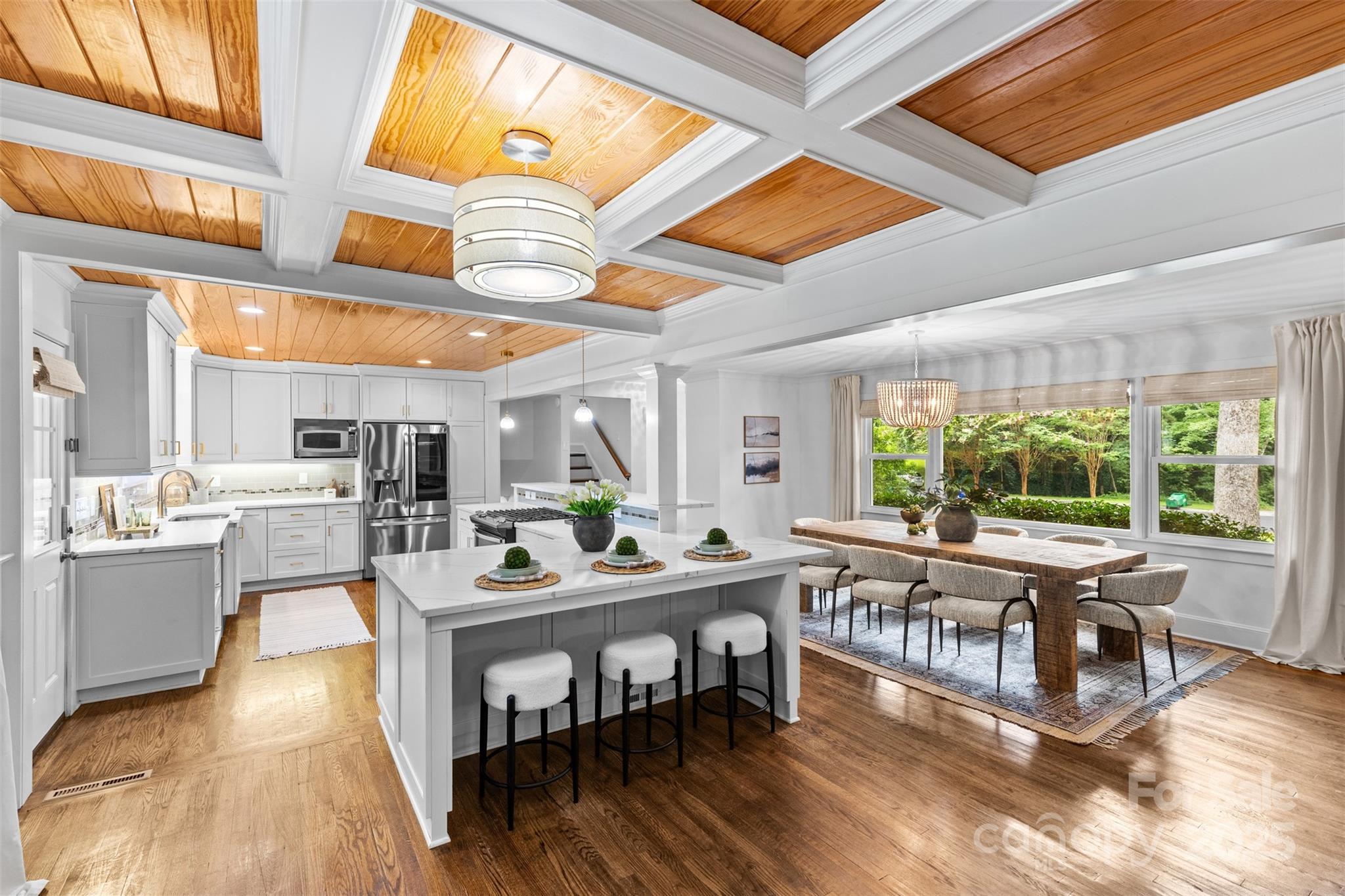 5611 Robinhood Road Charlotte, NC 28211 - Photo 9 of 48 a dining room with furniture a rug and a large window