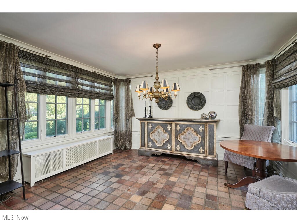 554 Merriman Road Akron, OH 44303 - Photo 8 of 35 featuring tile floors, a chandelier, ornamental molding. Side note, chandelier has been featured in a Hollywood movie.
