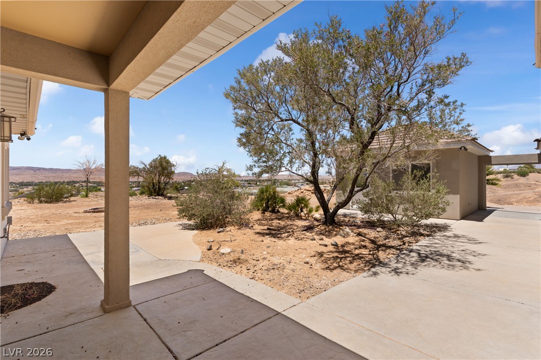 575 Gann Avenue Logandale, NV 89021 - Photo 59 of 75 A spacious covered patio offers desert views and seamless indoor-outdoor living.