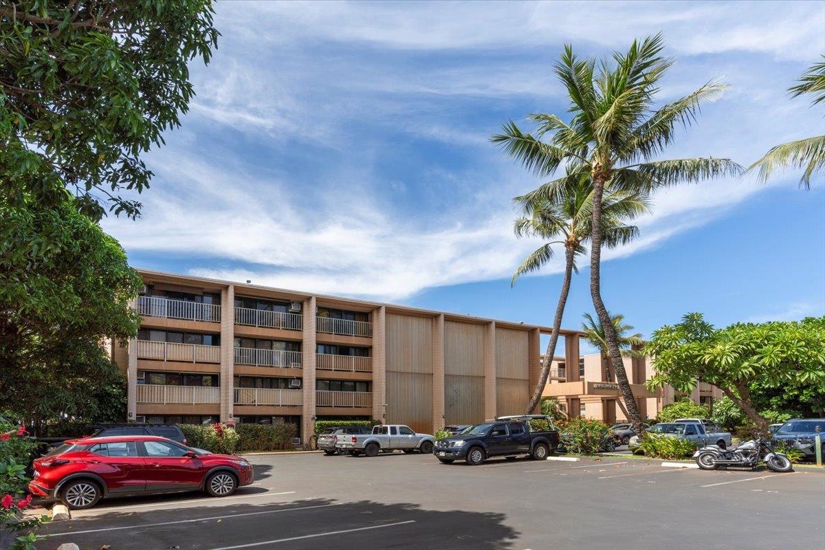 3785 Lower Honoapiilani Road, Unit 107 Lahaina, HI 96761 - Photo 29 of 30 a front view of a house with a yard and garage