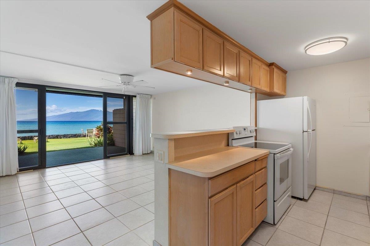 3785 Lower Honoapiilani Road, Unit 107 Lahaina, HI 96761 - Photo 7 of 30 a kitchen with a sink and cabinets