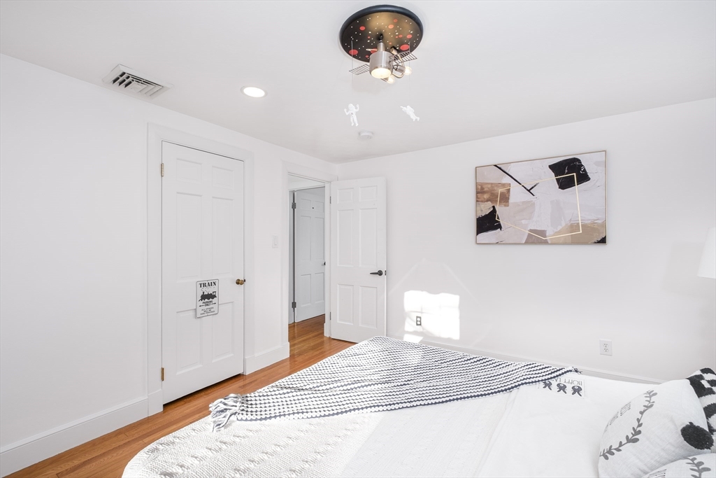 33 Sargent Road Winchester, MA 01890 - Photo 19 of 42 a bedroom with a bed and a chandelier