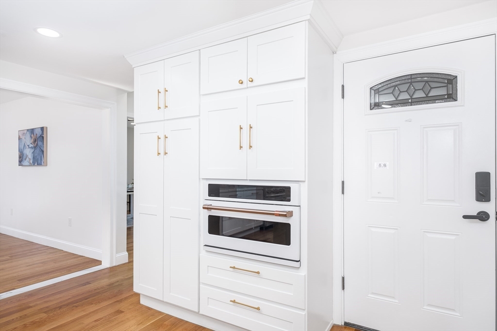 33 Sargent Road Winchester, MA 01890 - Photo 8 of 42 a kitchen with white cabinets and white appliances