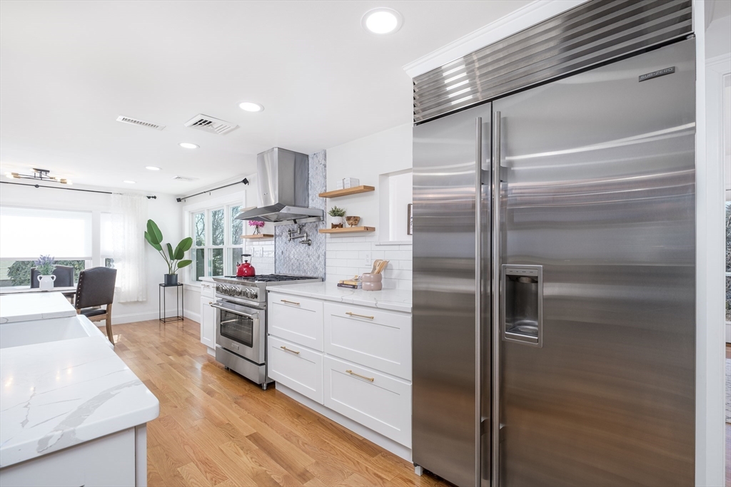 33 Sargent Road Winchester, MA 01890 - Photo 9 of 42 a kitchen with a refrigerator and white cabinets