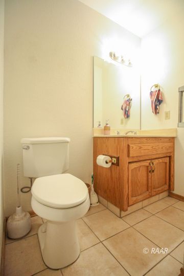 1124 Faith Court Ridgecrest, CA 93555 - Photo 32 of 35 a bathroom with a toilet and a sink