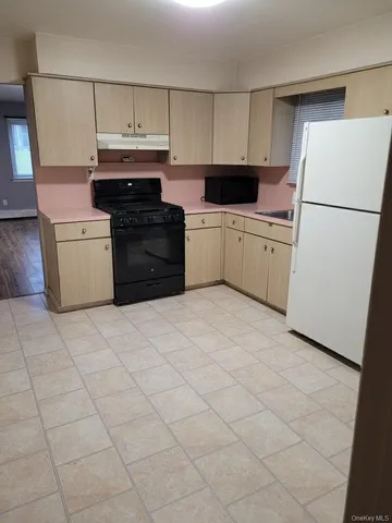 a kitchen with cabinets a refrigerator and a stove