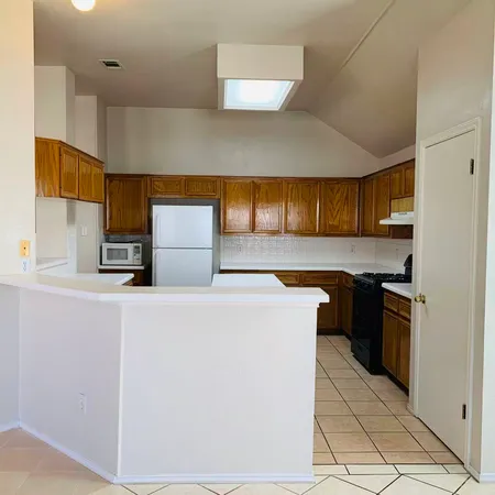 a kitchen with stainless steel appliances a stove a sink and a refrigerator