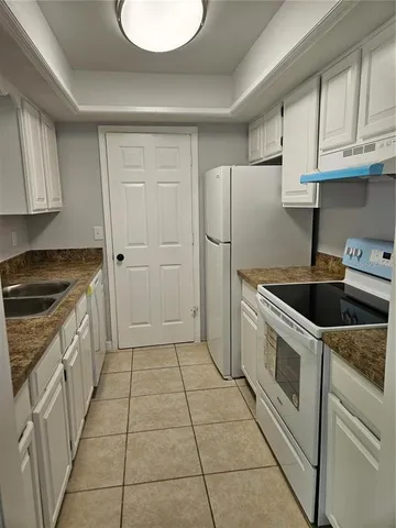 a kitchen with a cabinets and white appliances