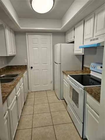 a kitchen with a cabinets and a stove top oven