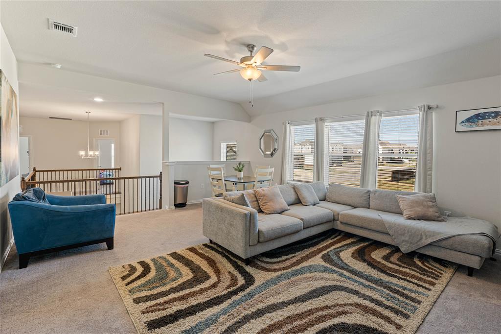 9517 Sunset Lane Oak Point, TX 75068 - Photo 27 of 40 9517 Sunset Lane, Oak Point, TX 75068 - Game Room - Carpeted game room featuring a ceiling fan, suspended lighting, and vaulted ceiling