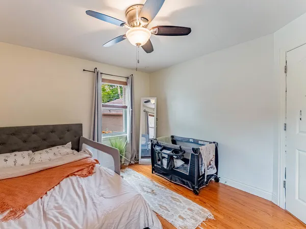 a bedroom with a bed dresser and a window