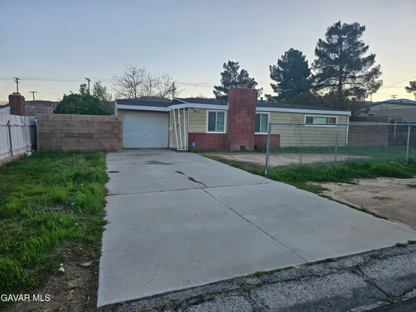 a view of a house with a yard and a garage
