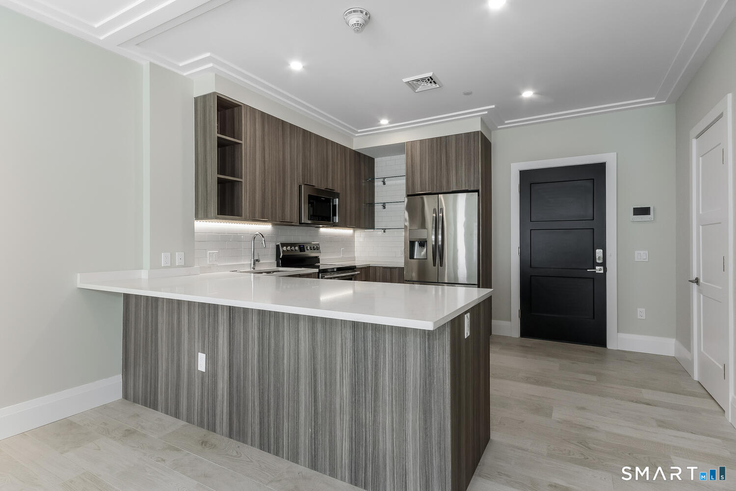 a kitchen with stainless steel appliances a refrigerator and a sink