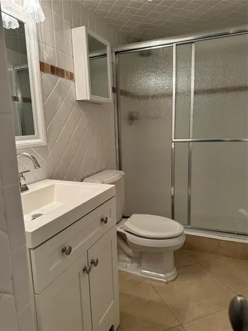 a kitchen with stainless steel appliances a refrigerator a sink dishwasher a stove and white countertops with wooden floor