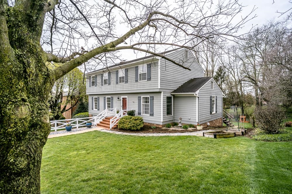a front view of house with yard and green space