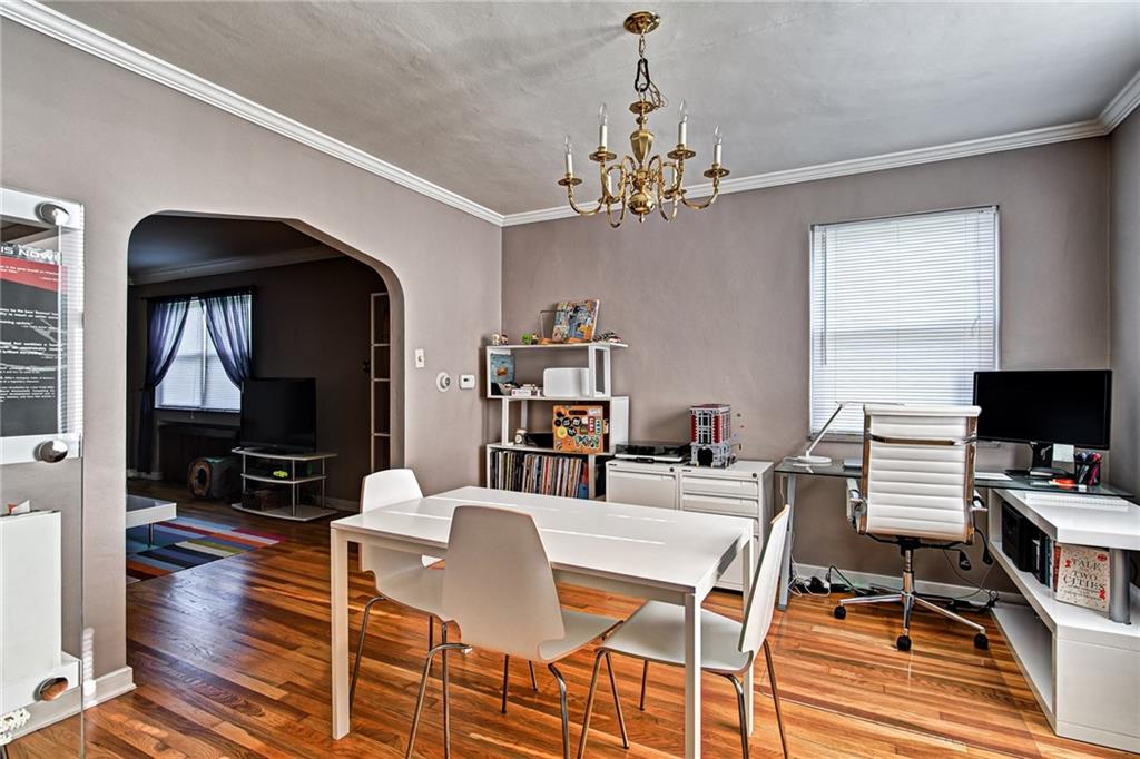 1343 Anderson Road Pittsburgh, PA 15209 - Photo 12 of 20 a view of a dining room with furniture a chandelier and wooden floor