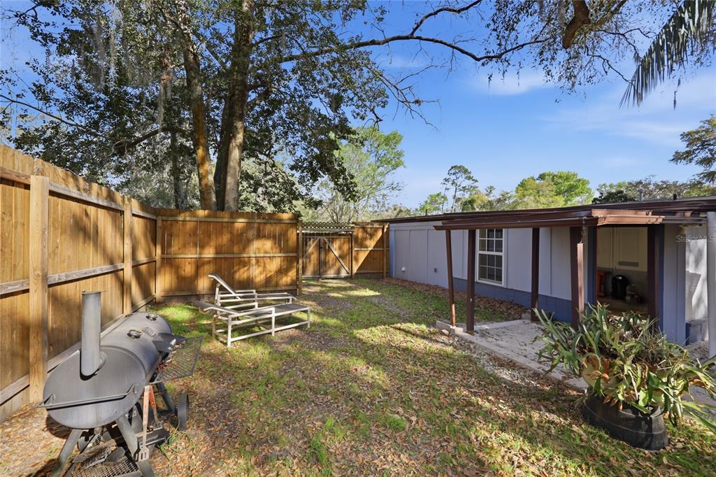 314 Northwest 36th Terrace Gainesville, FL 32607 - Photo 40 of 49 a view of a chair and table in the backyard