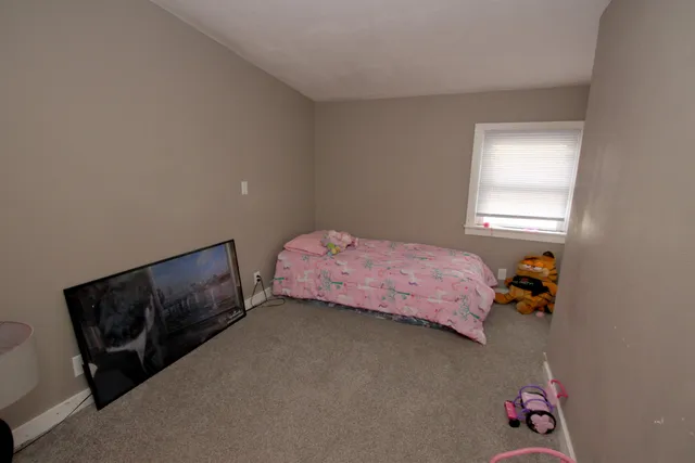 a bedroom with a bed and window