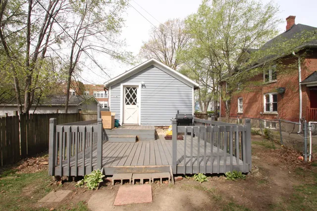 a view of a house with wooden fence