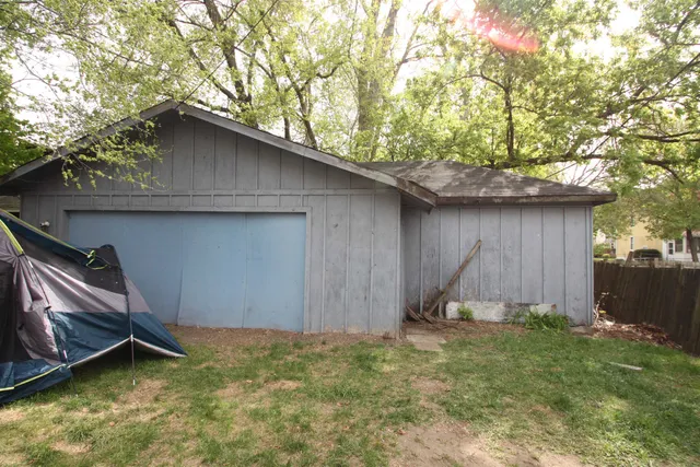 a backyard of a house with barbeque oven