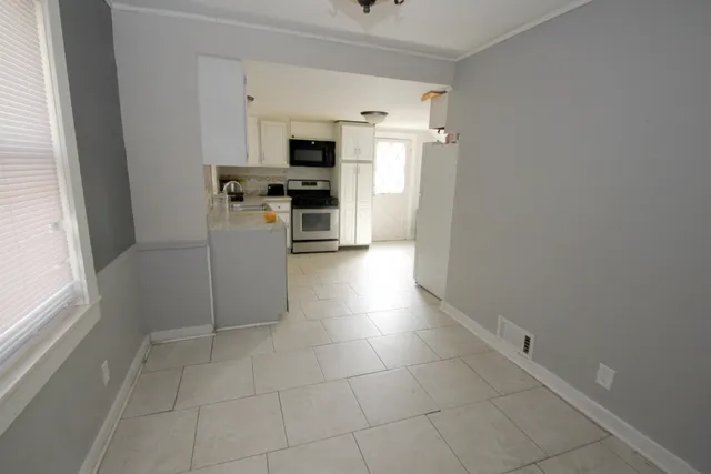 a kitchen with stainless steel appliances a stove a microwave and a refrigerator