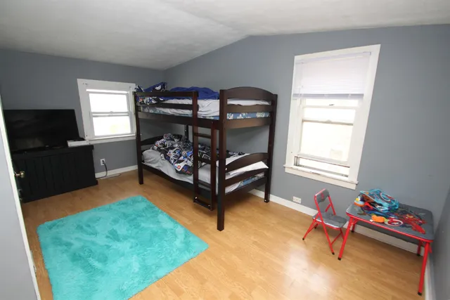 a bedroom with furniture and a window