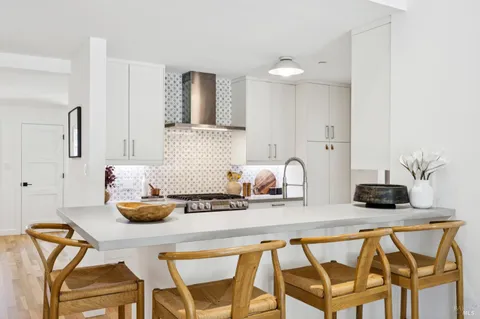 a kitchen with stainless steel appliances a sink stove and refrigerator