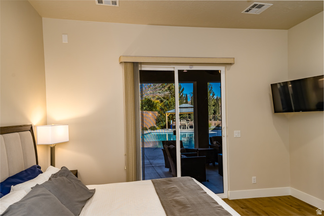 1283 North Gallen Road Santa Clara, UT 84765 - Photo 29 of 103 Primary Bedroom featuring wood finished floors and access to exterior