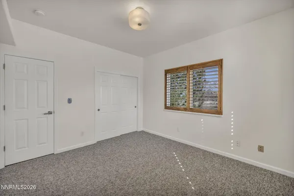 a view of room with ceiling fan and window