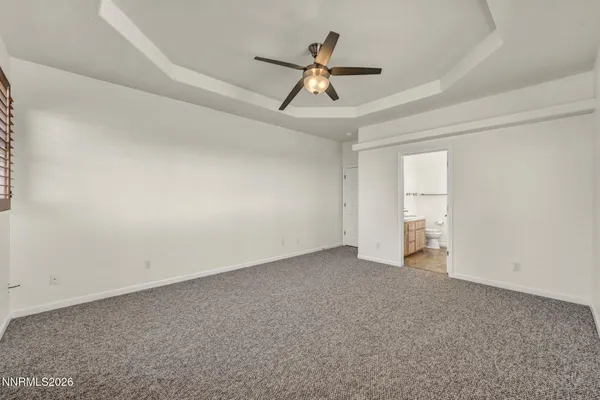 a bedroom with a bed a table and chair