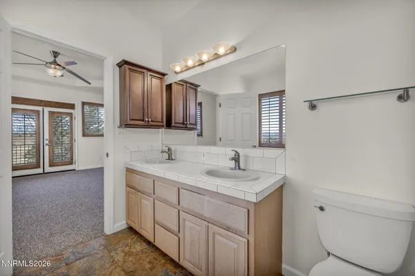 a bathroom with a sink a toilet and mirror