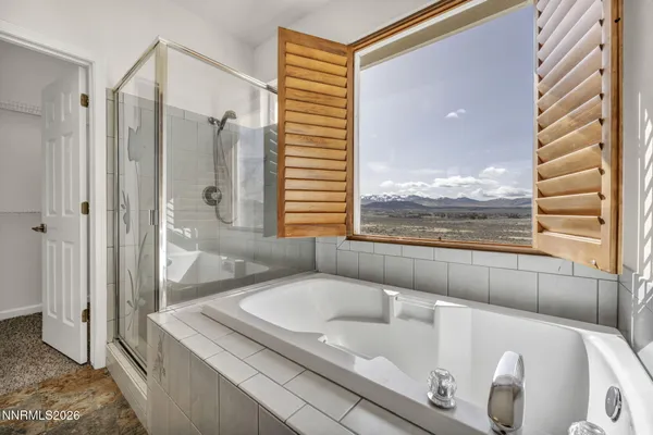 a bathroom with a tub shower and toilet