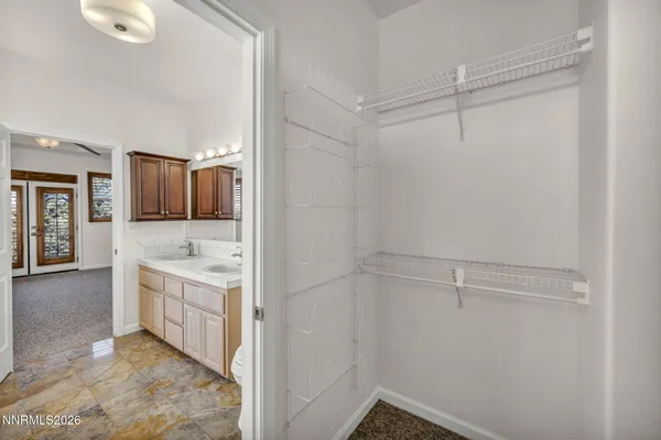 a bedroom with bed and a chandelier