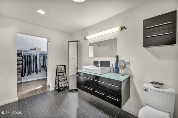 a room with stainless steel appliances kitchen island granite countertop a stove and a refrigerator