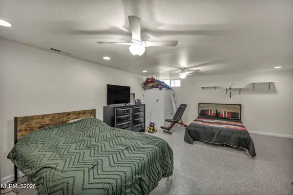a bedroom that has a bed and a chandelier