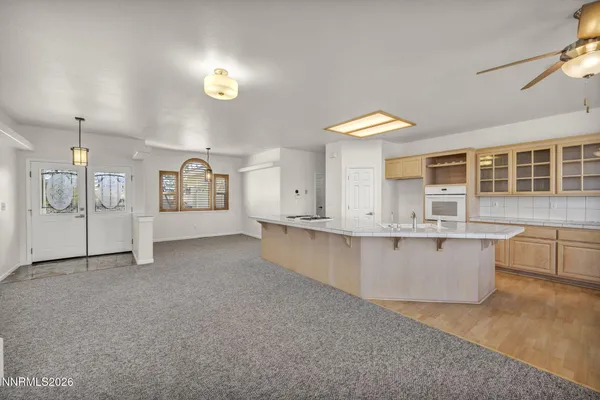 a large kitchen with kitchen island a large counter top space and a center island