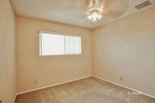 548 East Laura Avenue Ridgecrest, CA 93555 - Photo 30 of 34 an empty room with a window and a chandelier fan